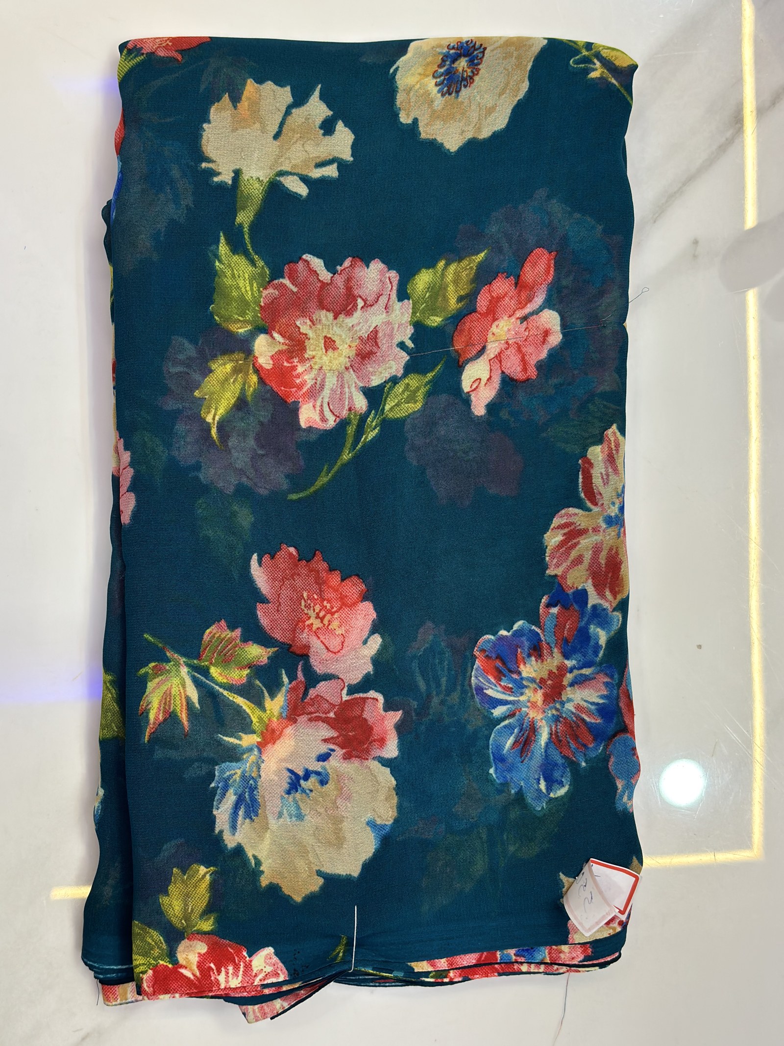 Deep teal saree with a colourful floral print
